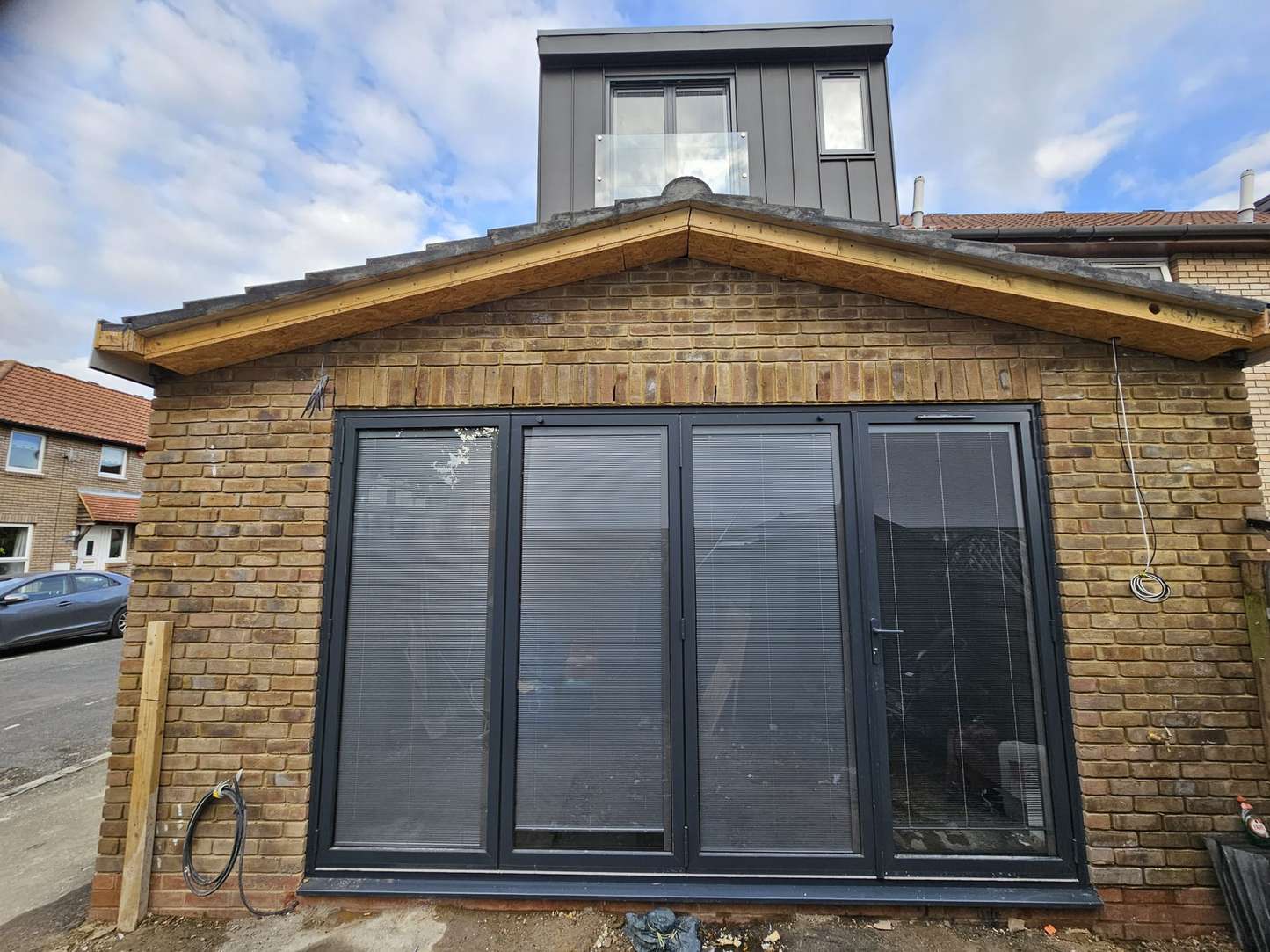 Black aluminium bifold doors in a new brick extension